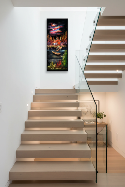 Moonlit lakeside cabin painting displayed on staircase wall in luxury home interior