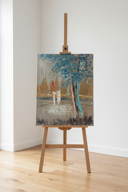 Original misty park teal tree oil painting displayed on wooden easel stand in bright modern interior